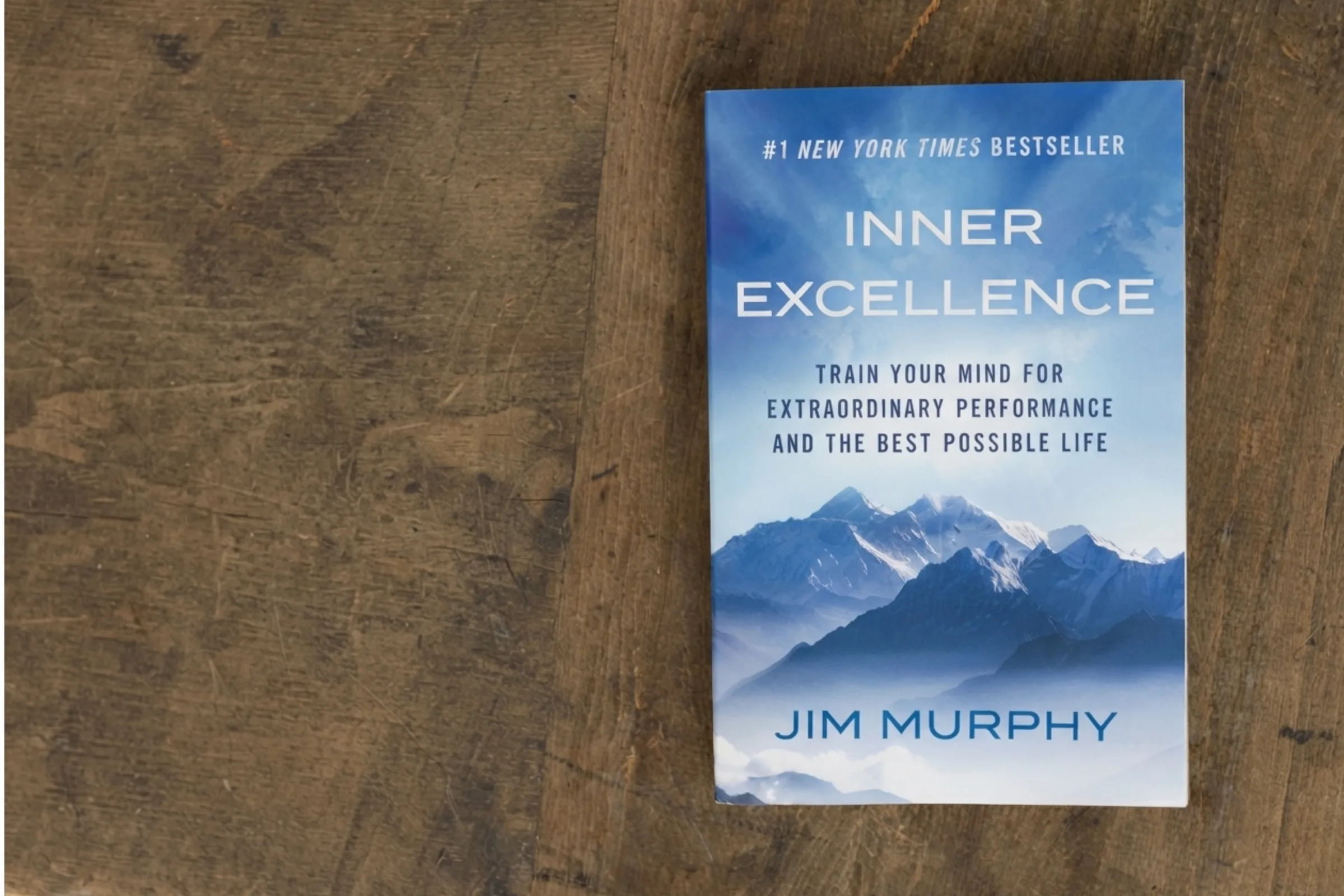 A copy of Inner Excellence by Jim Murphy lying on a wooden table